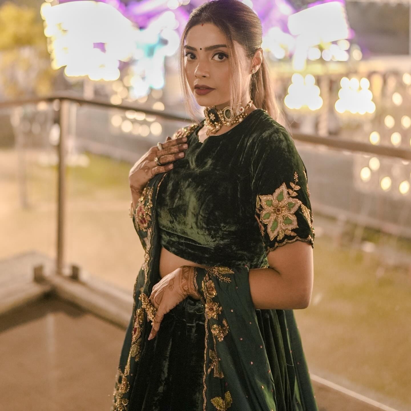 Pooja Kalyani in green velvet and a kundan choker against evening lights